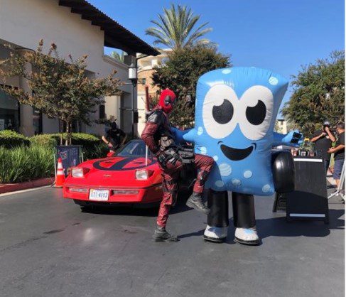 Soapy Joe posing with Deadpool in front of the Deadpool car at the Cruise for the Cause event in Chula Vista.